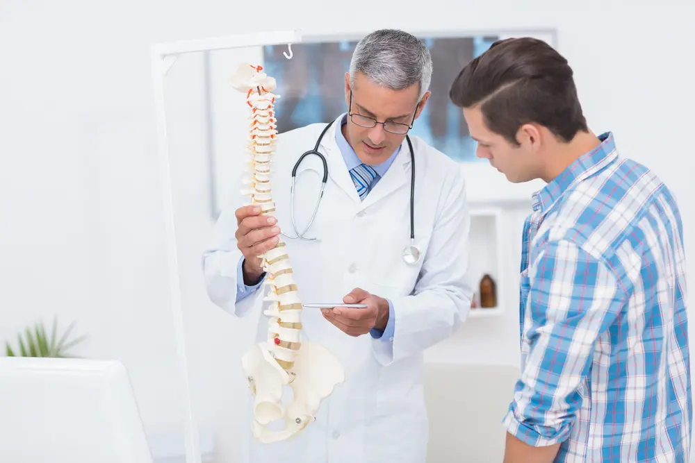 Medical-Doctor-explaining-back-pain-symptoms-to-patient