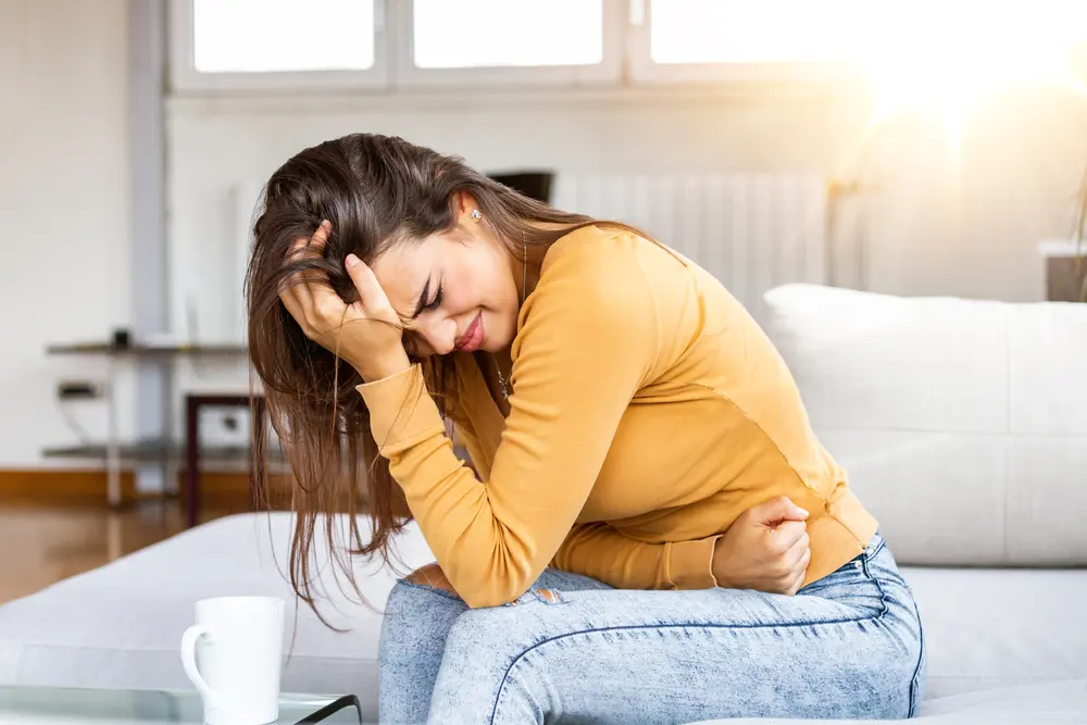Young-female-having-stomach-pain-due-to-digestion-issues