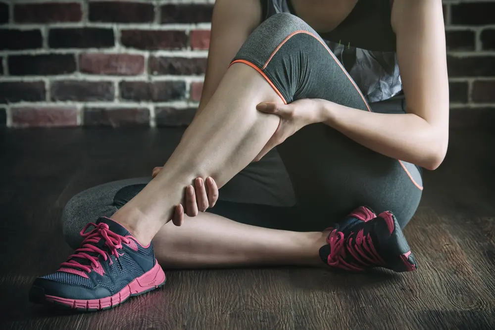 woman-having-muscle-cramps-in-a-leg-while-in-fitness-exercise-training
